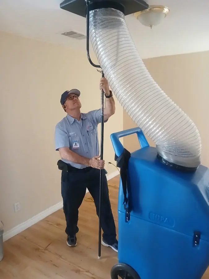 Furnace Tune-Up technician using HEPA equipment in Pequannock